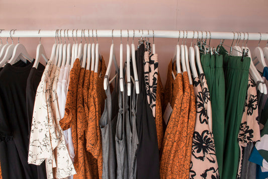 Assorted clothing hanging on a rack ready for resale pricing