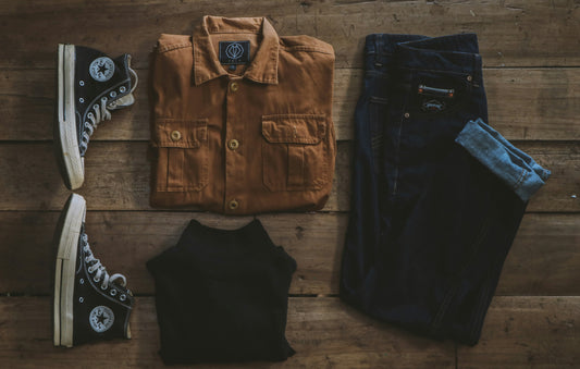 Camera and folded denim shirt set up for clothing photography